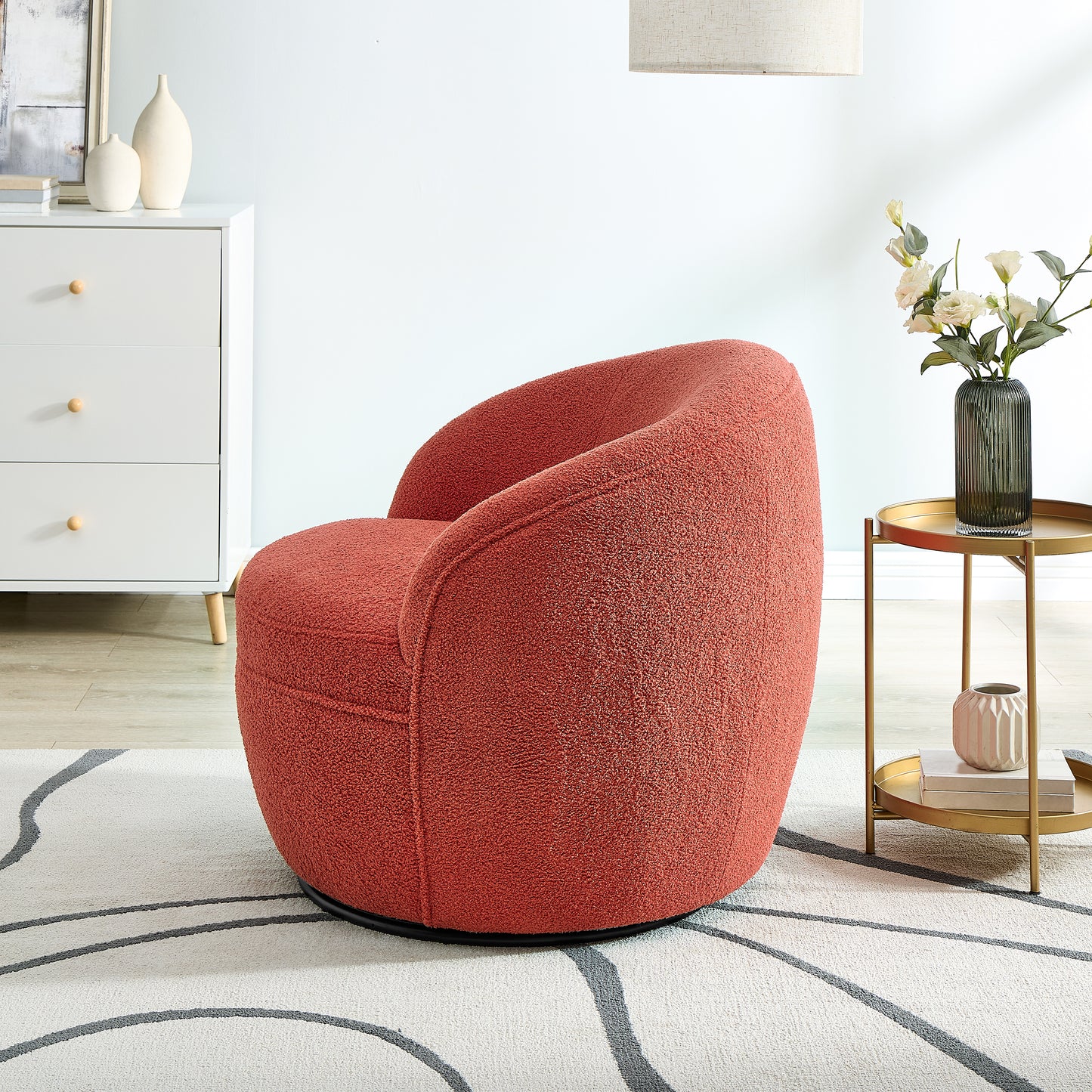 Coral boucle swivel armchair with plush texture and modern design