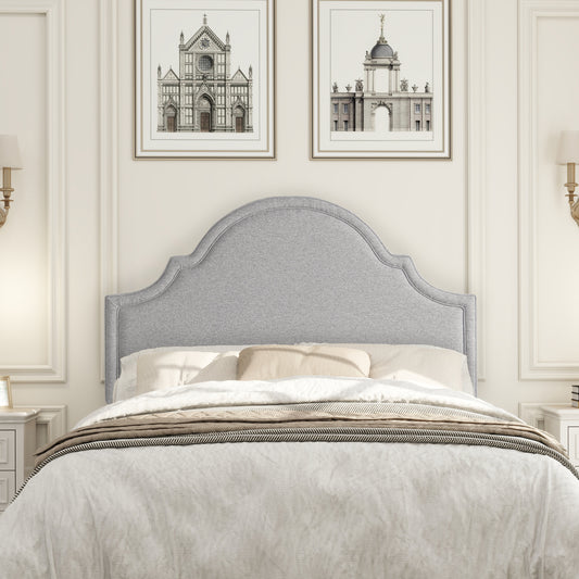 Grey upholstered headboard with scalloped top for a classic bedroom style