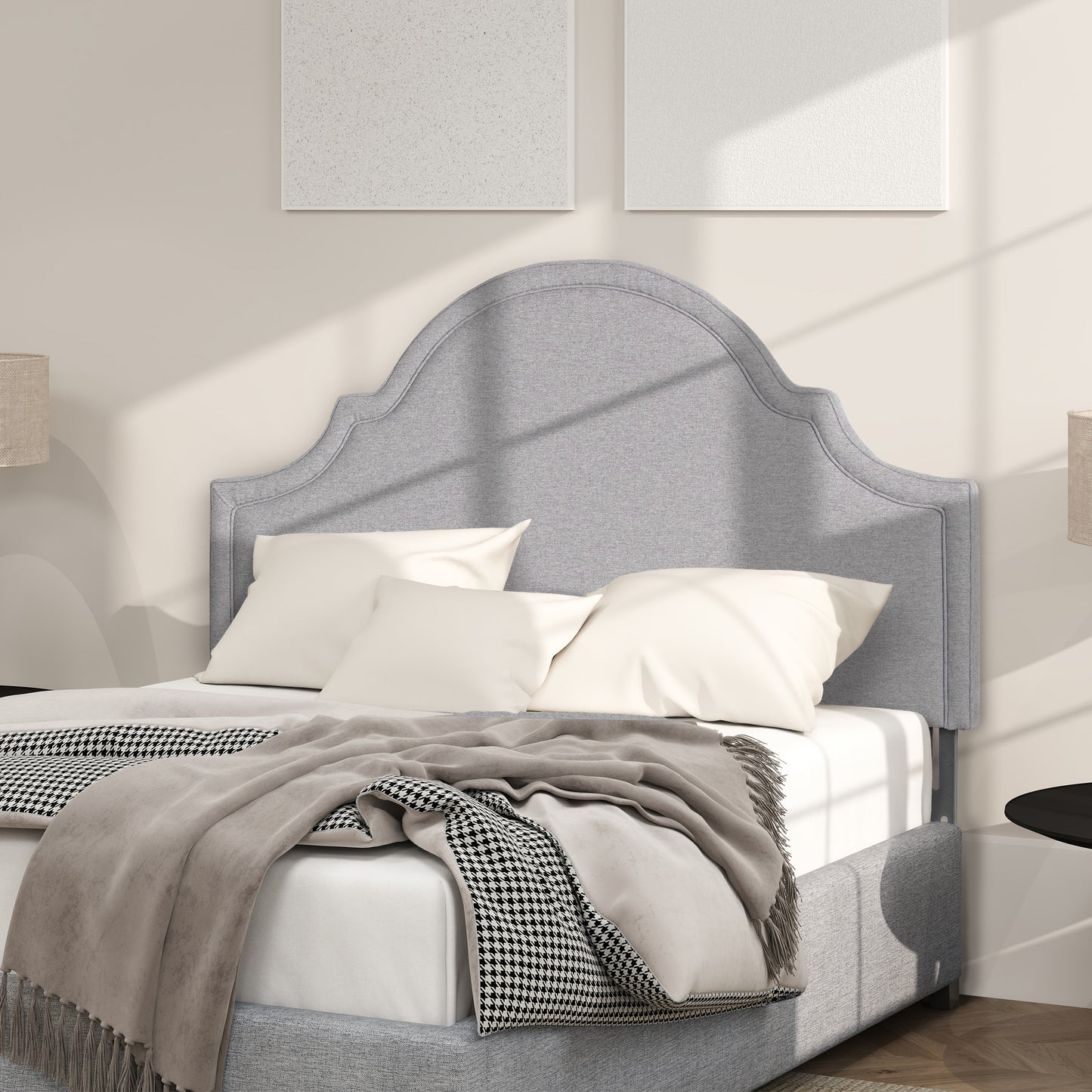 Grey fabric headboard with curved top on upholstered bed frame