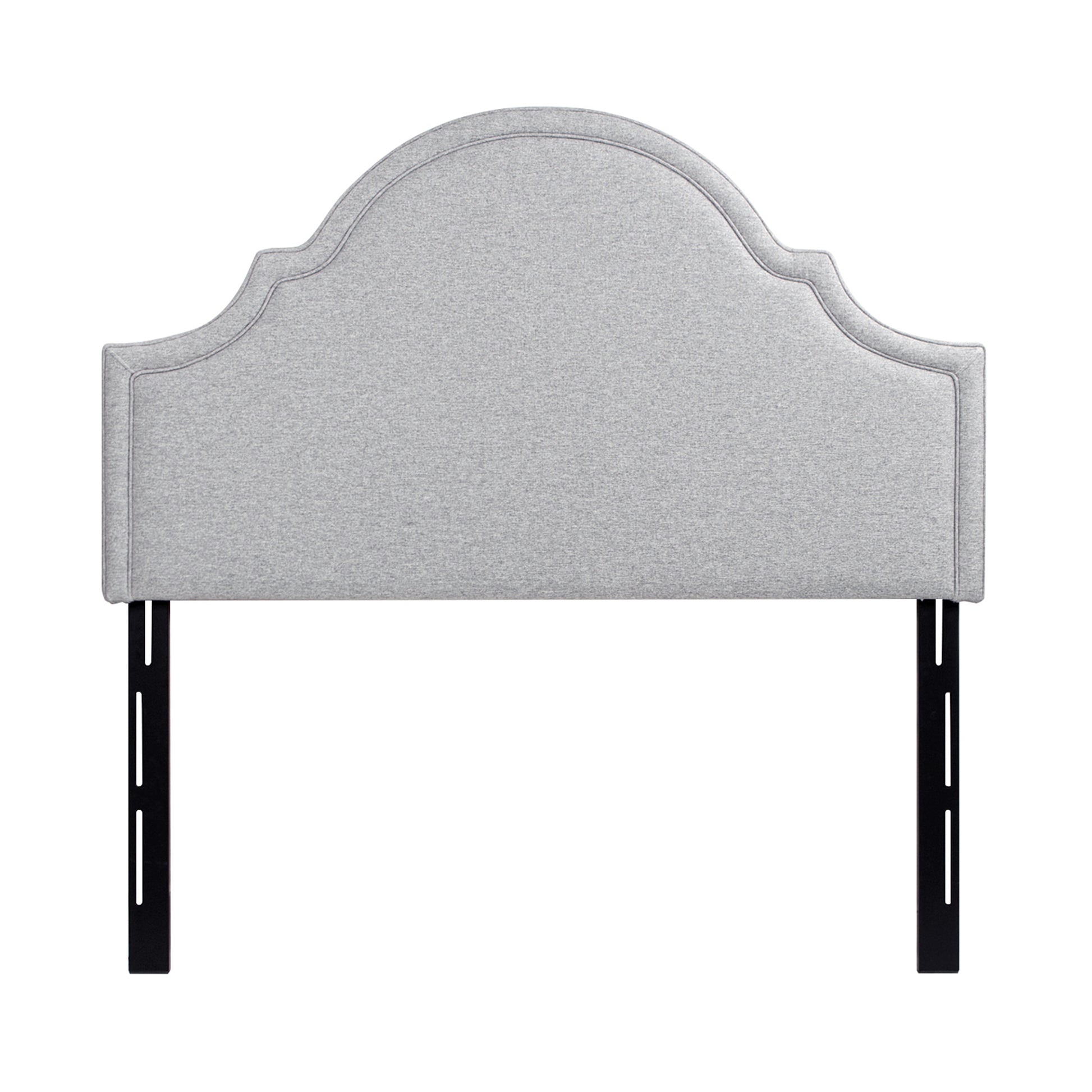 Light grey fabric headboard with a scalloped top and upholstered frame for a queen bed