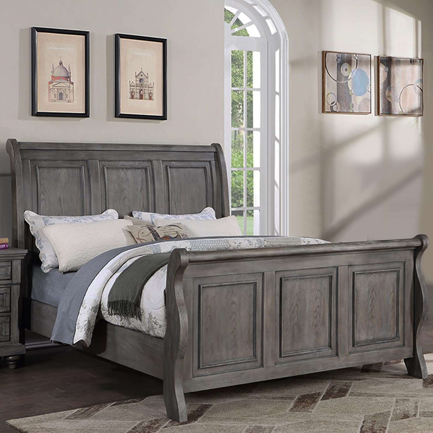 Gray wooden sleigh bed frame with panel detailing and plush bedding