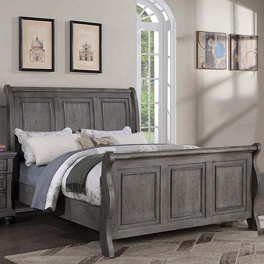 Gray wooden sleigh bed frame with panel detailing and plush bedding