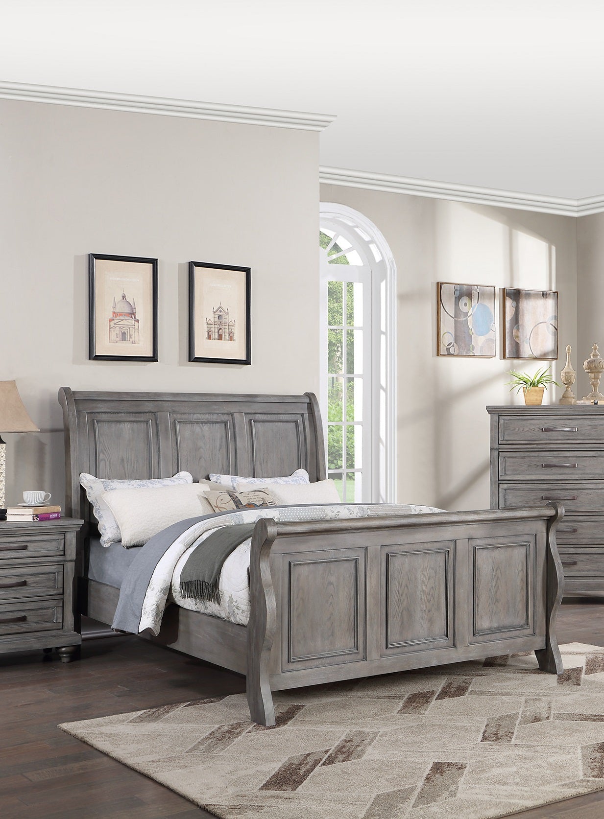 Gray wooden sleigh bed with carved paneling and upholstered headboard perfect for a classic bedroom