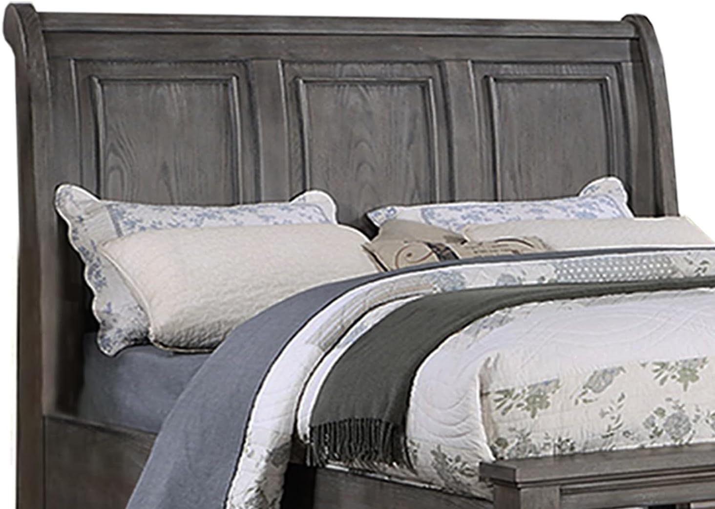 Gray wood sleigh headboard with paneled design and decorative pillows