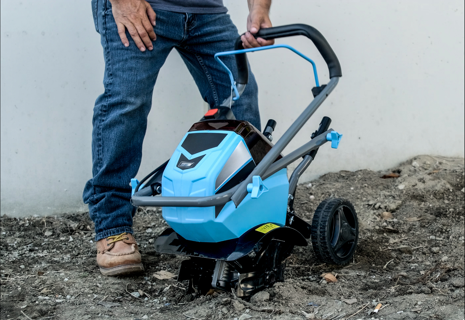 Compact electric tiller with bright blue housing ideal for small garden beds