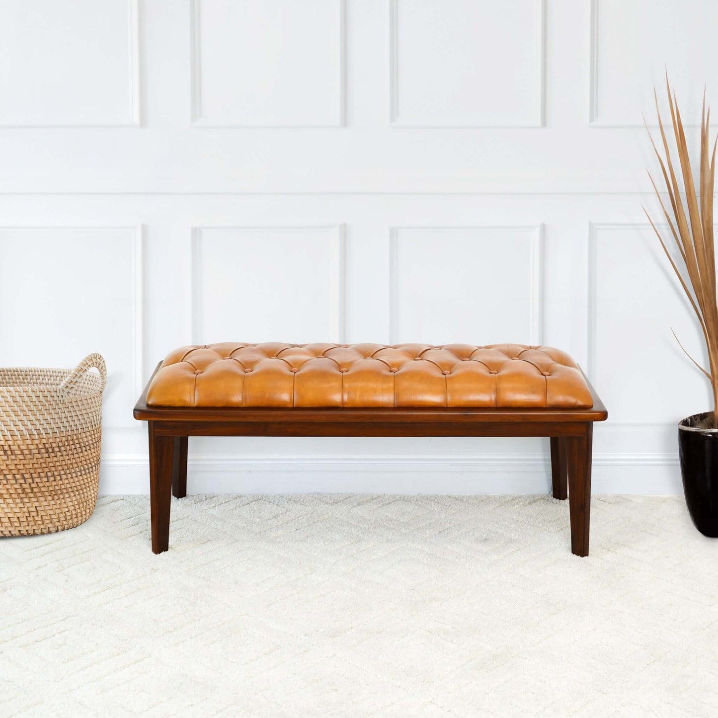 Tufted cognac leather bench with dark wood frame ideal for entryways and living rooms