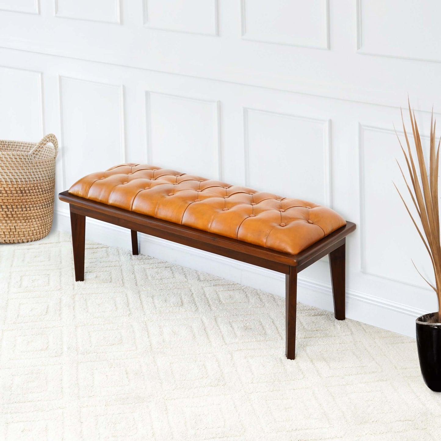 Tufted caramel leather bench with dark wood legs perfect for entryways