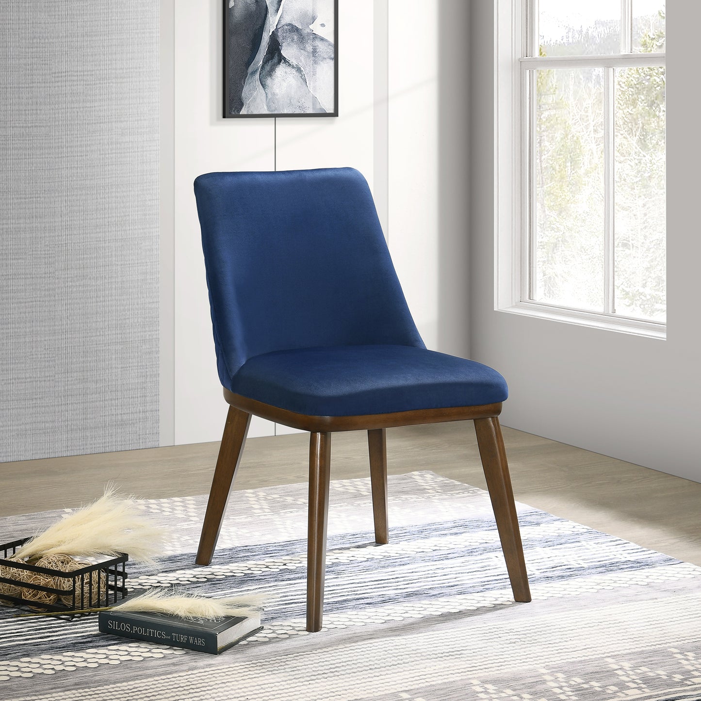 A modern navy blue velvet accent chair with walnutfinished tapered legs