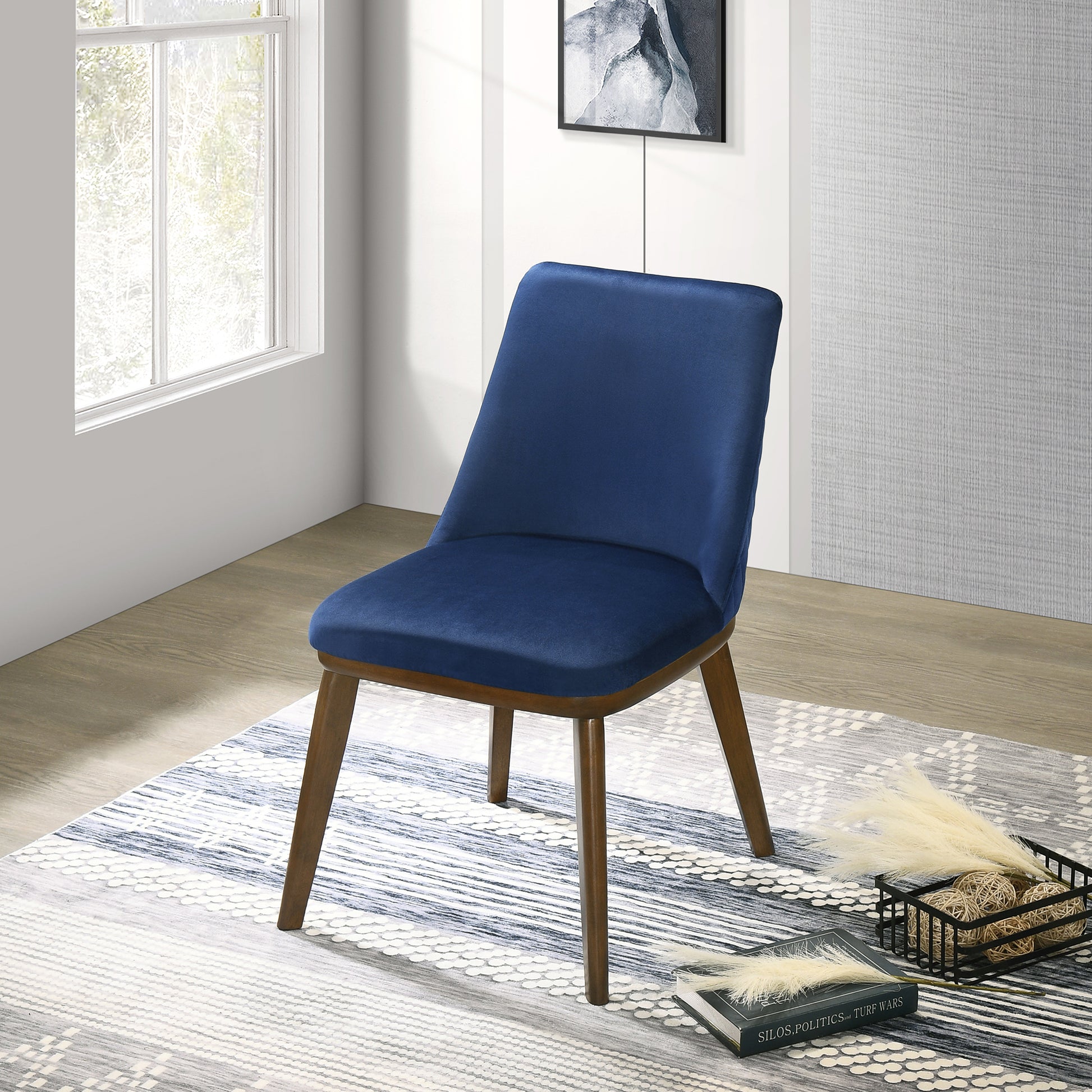 Navy blue velvet upholstered dining chair with tapered wooden legs