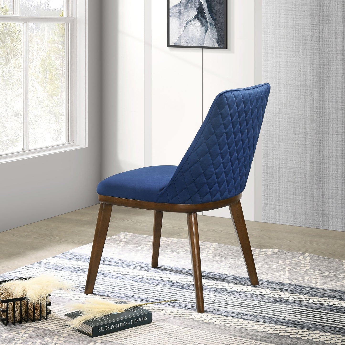 Quilted blue velvet accent chair with dark wood legs and diamond stitching