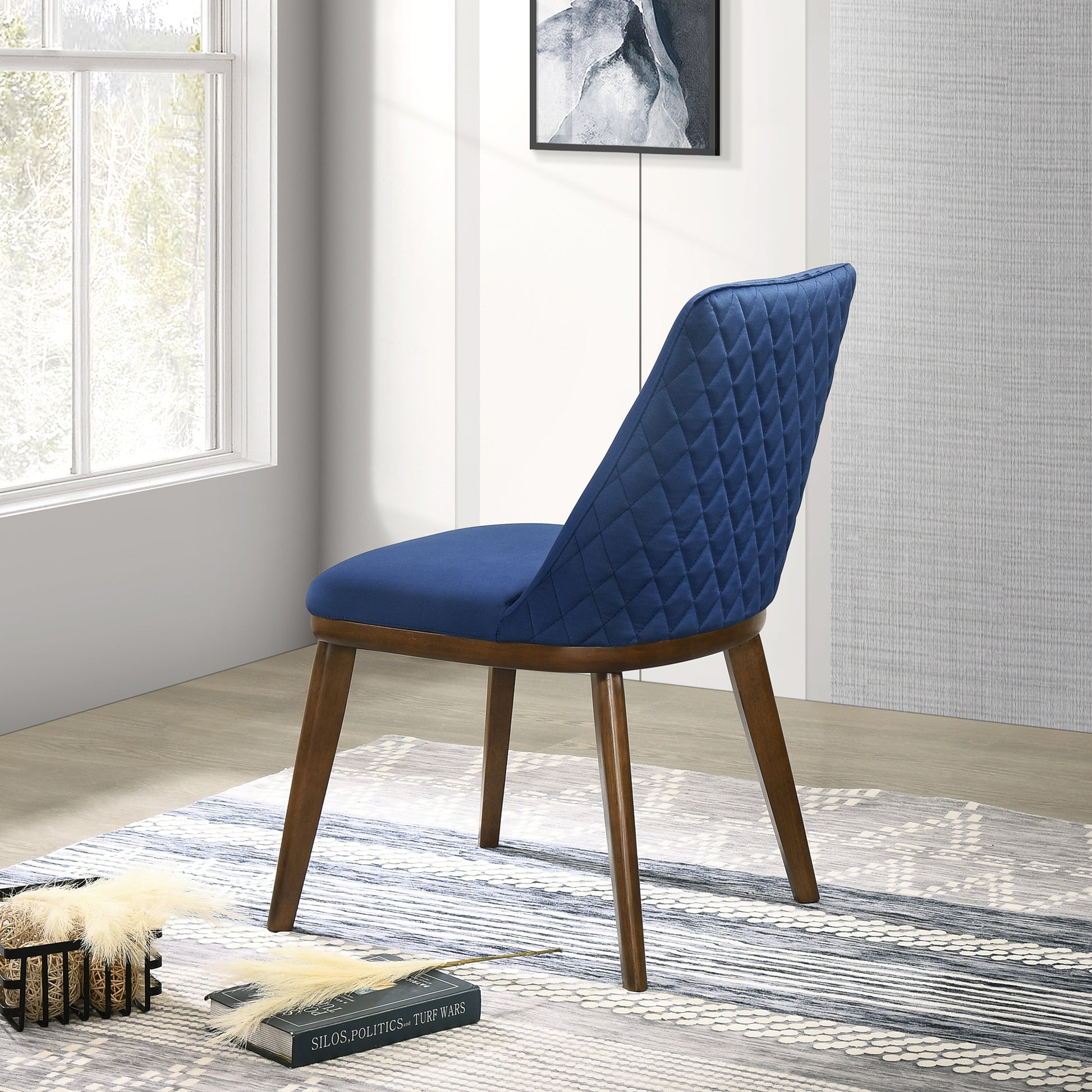 Quilted blue velvet accent chair with dark wood legs and diamond stitching