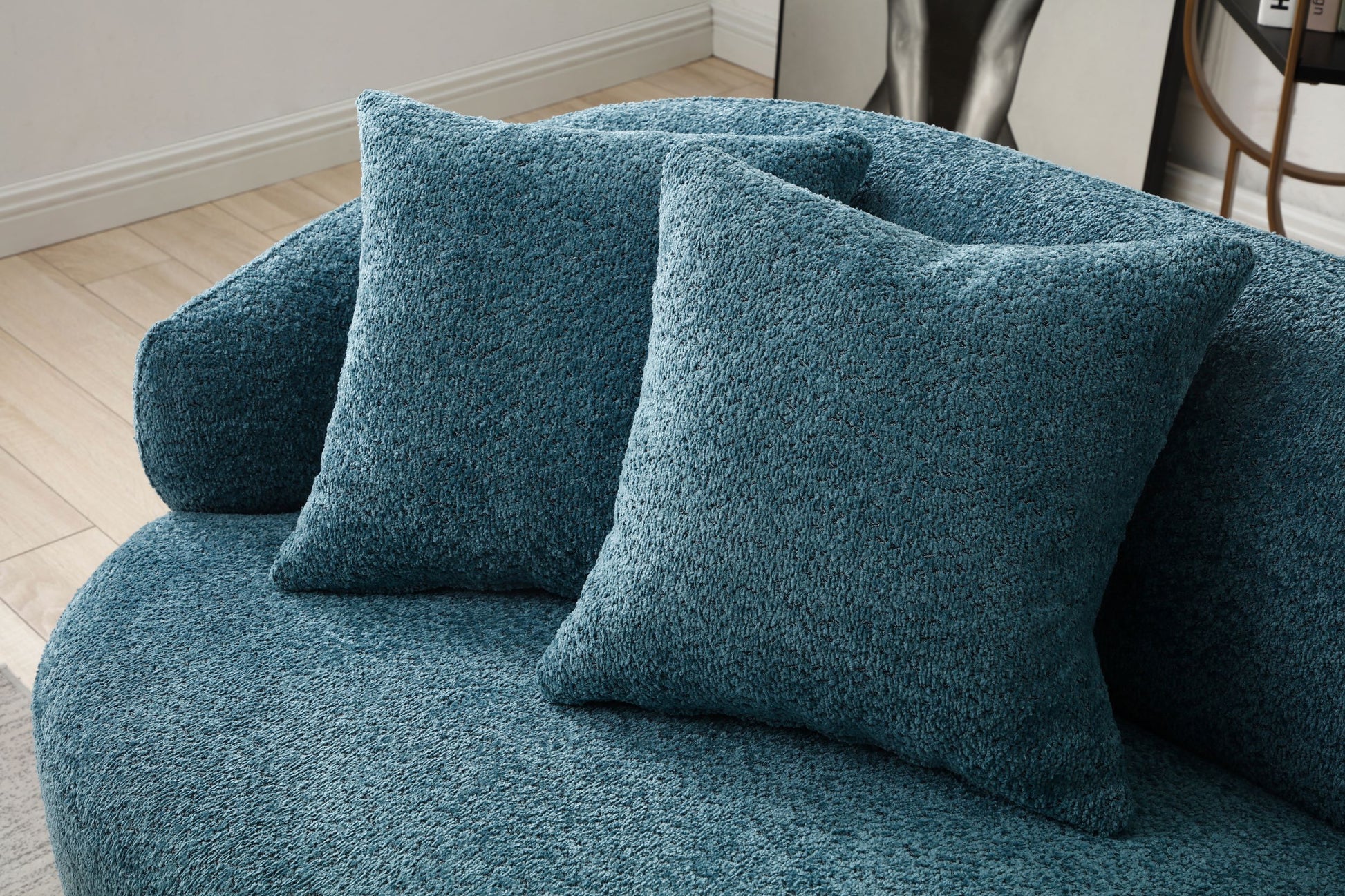 Teal textured throw pillows on a cozy boucle fabric sofa for living room comfort