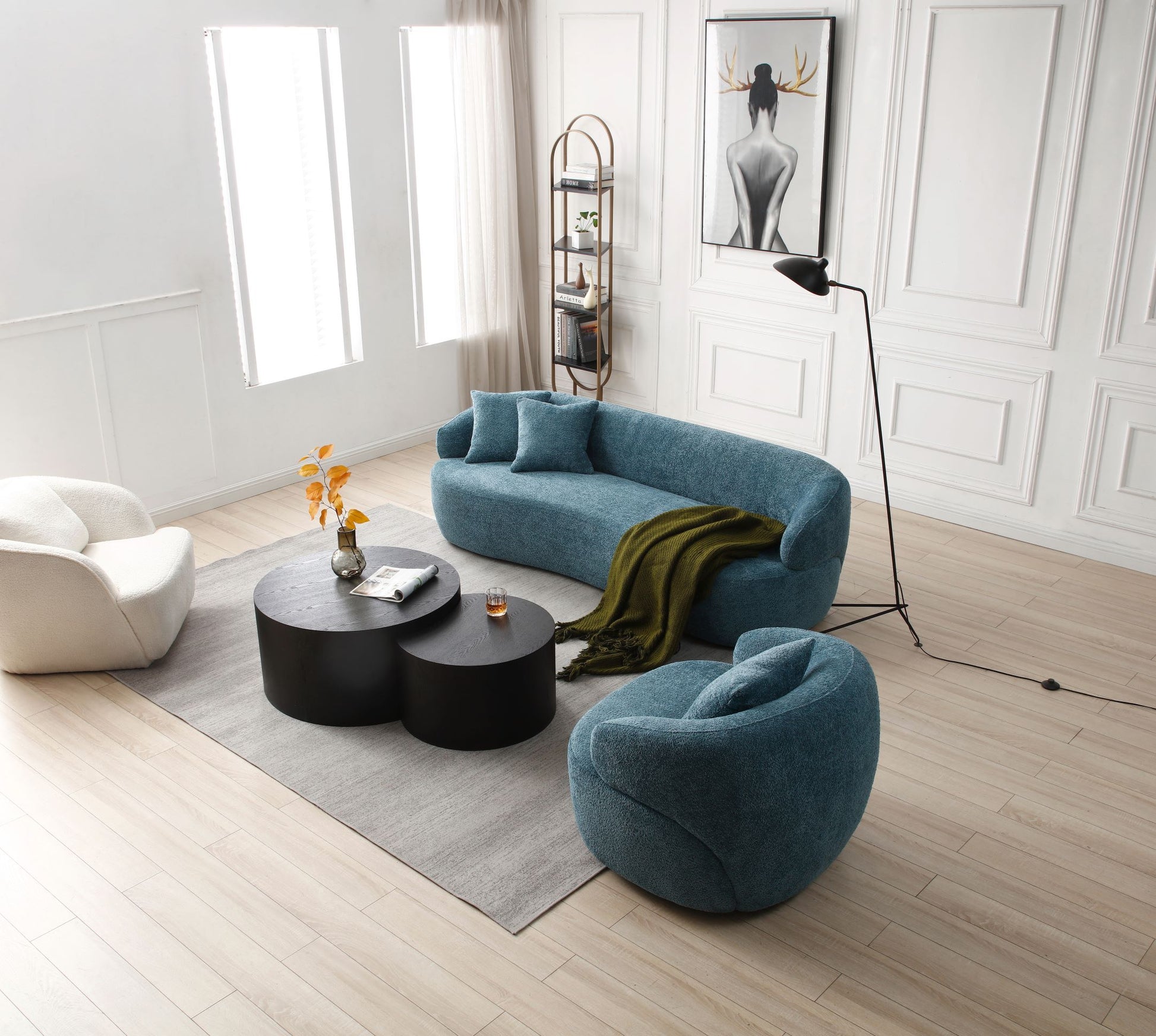 Curved teal boucle sofa with two pillows and green throw for modern living room
