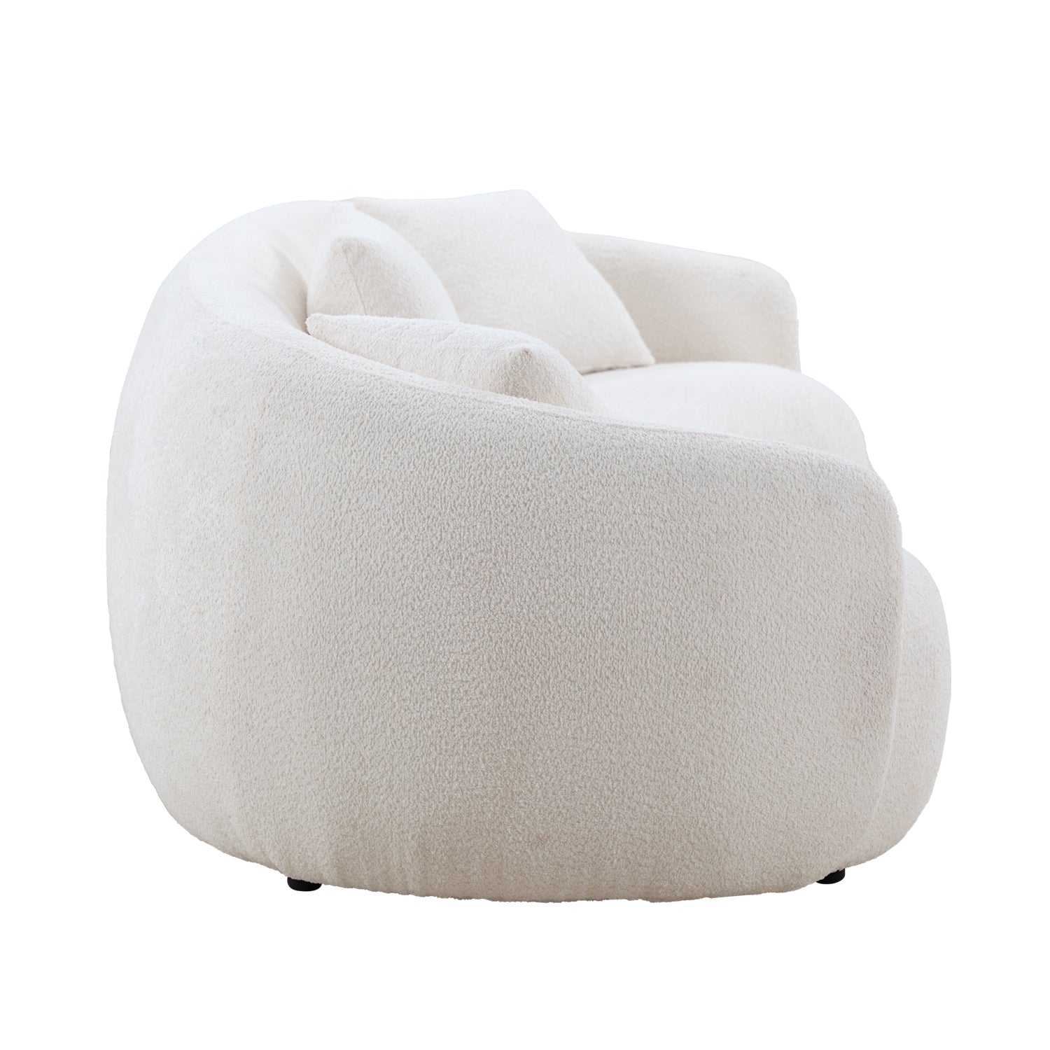Plush cream boucle armchair with rounded silhouette and two accent pillows