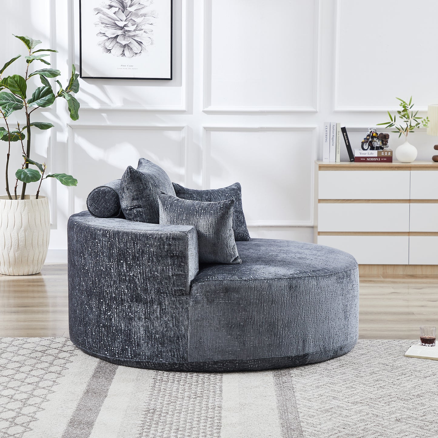 Plush velvet round sofa in charcoal gray with textured fabric and accent pillows