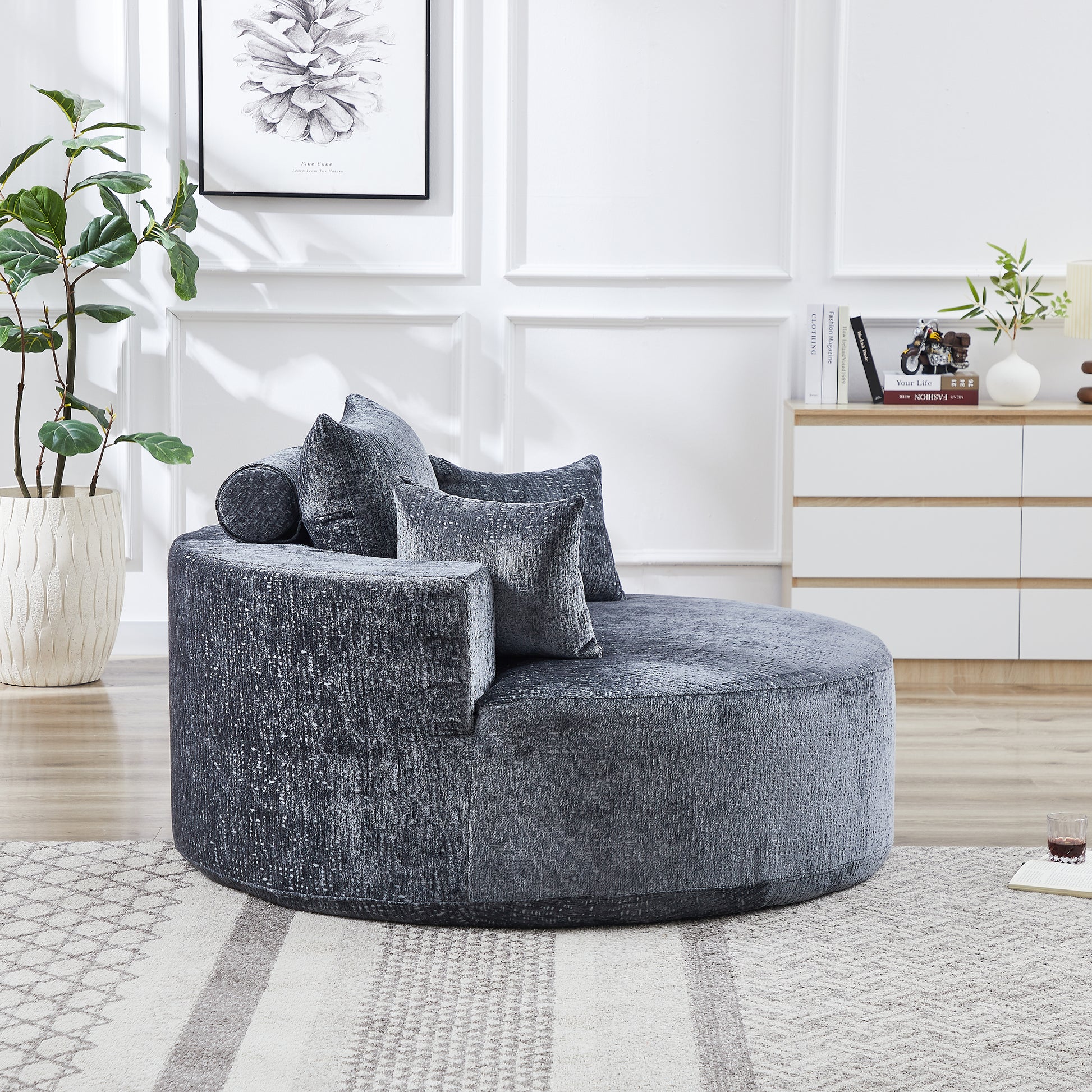 Plush velvet round sofa in charcoal gray with textured fabric and accent pillows