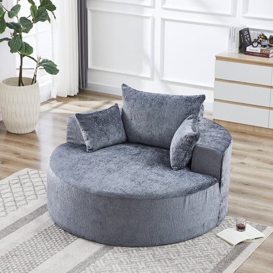 Round grey accent chair with plush velvet texture and multiple throw pillows