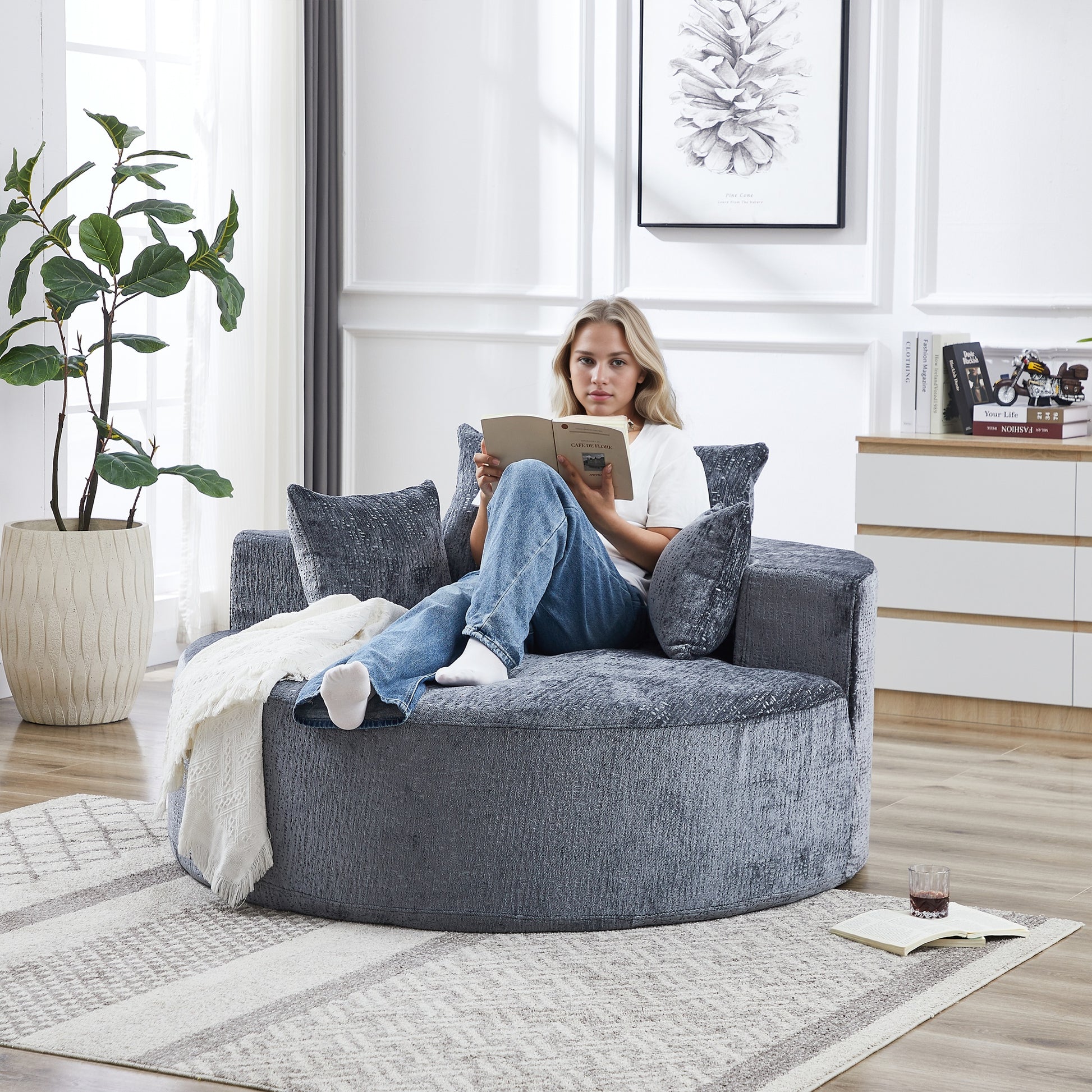 Plush grey circular sofa with textured fabric and plush cushions ideal for cozy living rooms