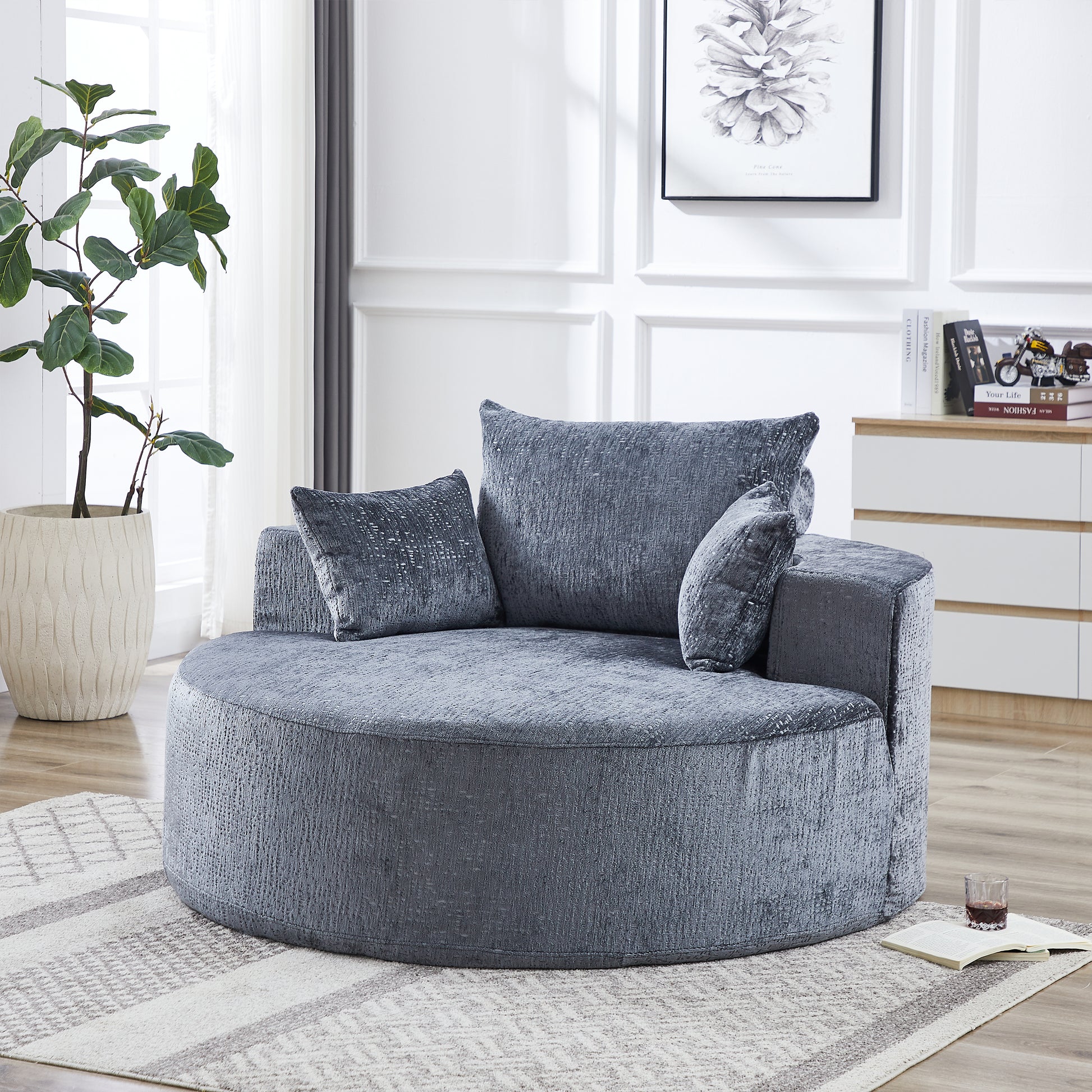 Round grey plush accent chair with textured fabric and matching pillows