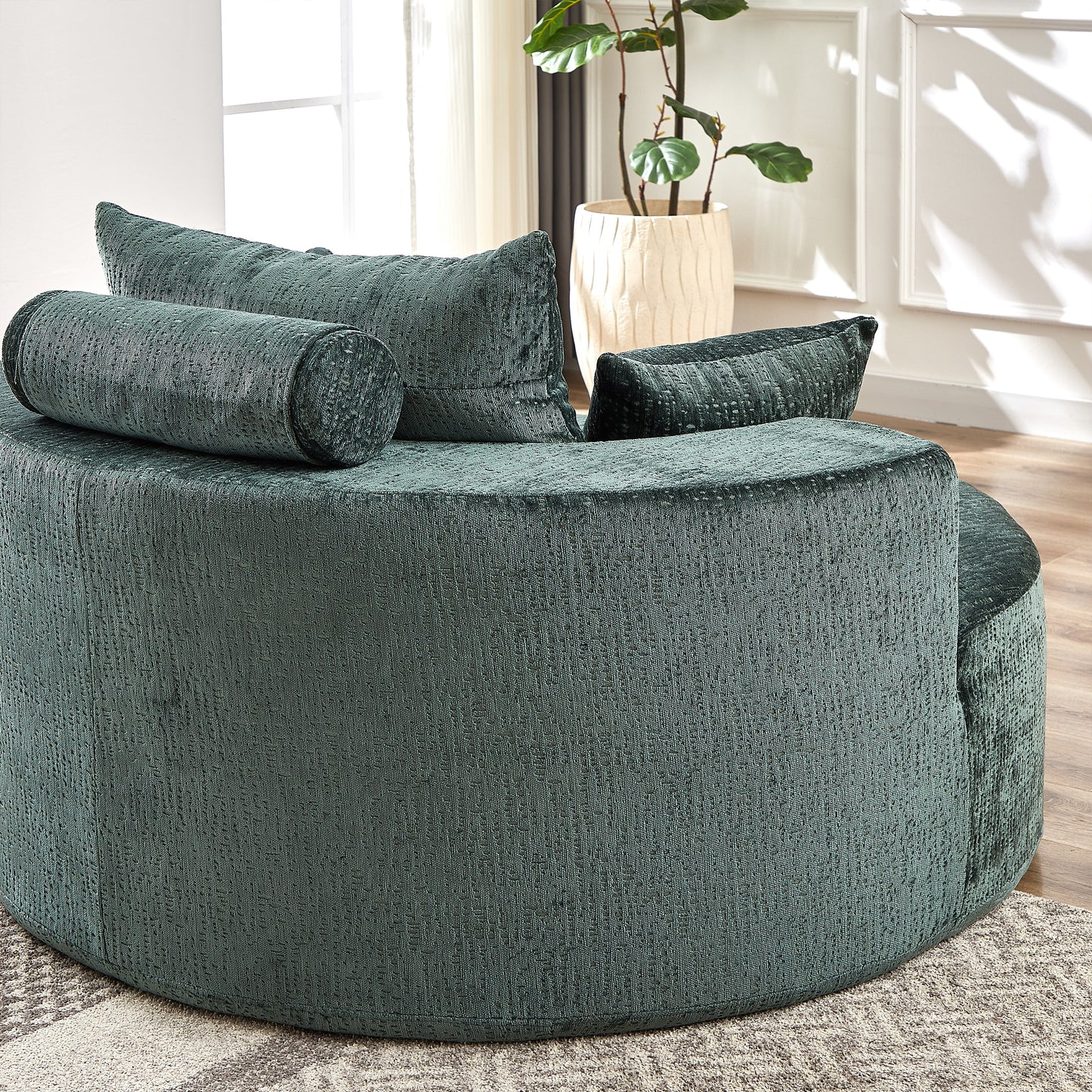Deep green textured fabric swivel chair with matching bolster and square throw pillows
