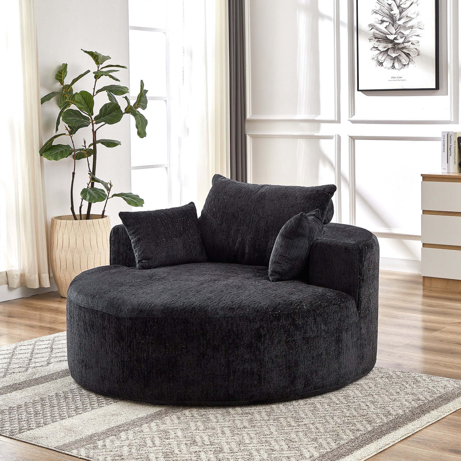 Plush black swivel accent chair with deep seating and comfortable throw pillows