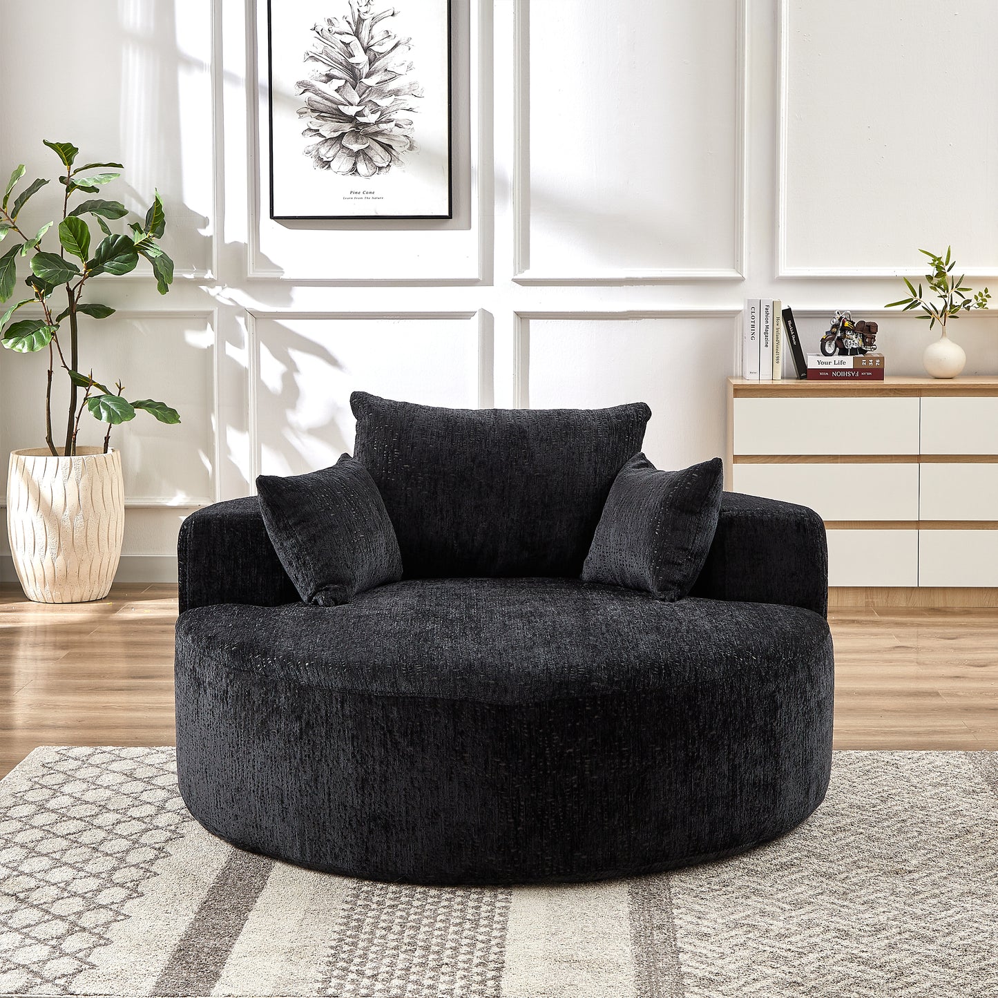 Plush charcoal grey swivel armchair with textured fabric and matching throw pillows