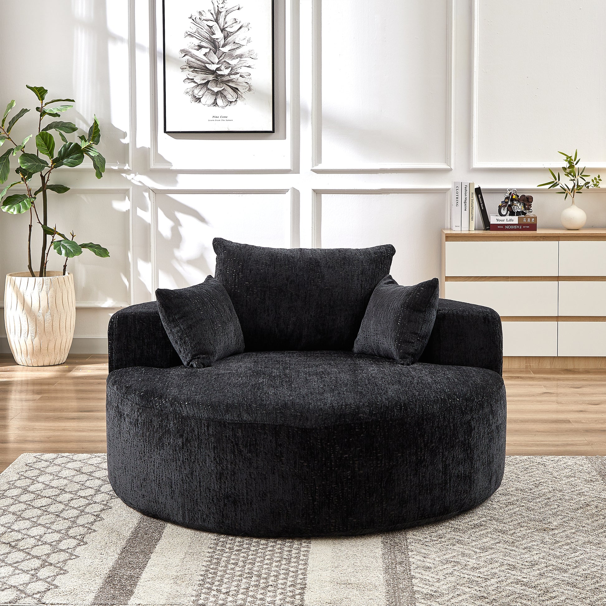 Plush charcoal grey swivel armchair with textured fabric and matching throw pillows