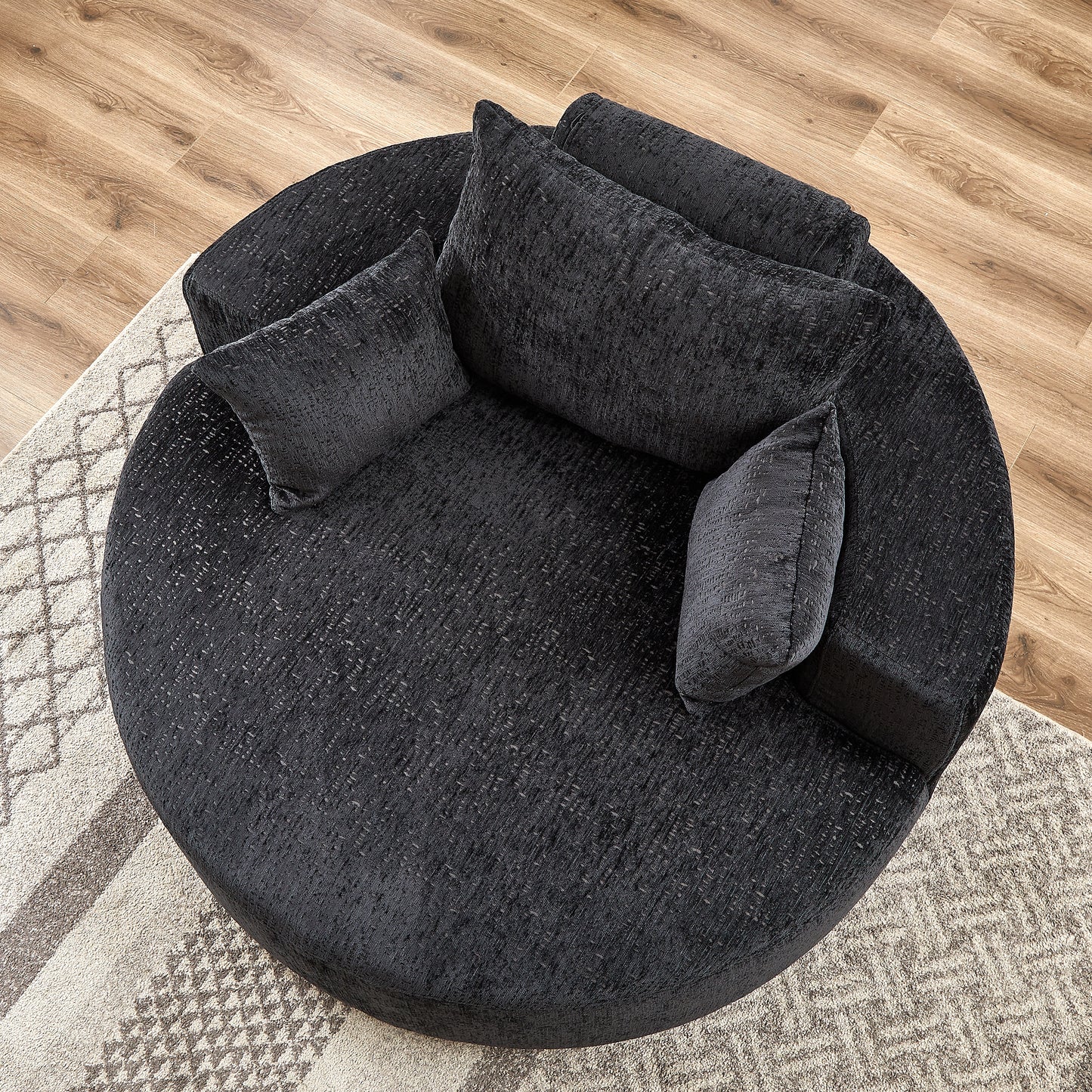 Plush charcoal round sofa with textured fabric and four accent pillows perfect for cozy living rooms