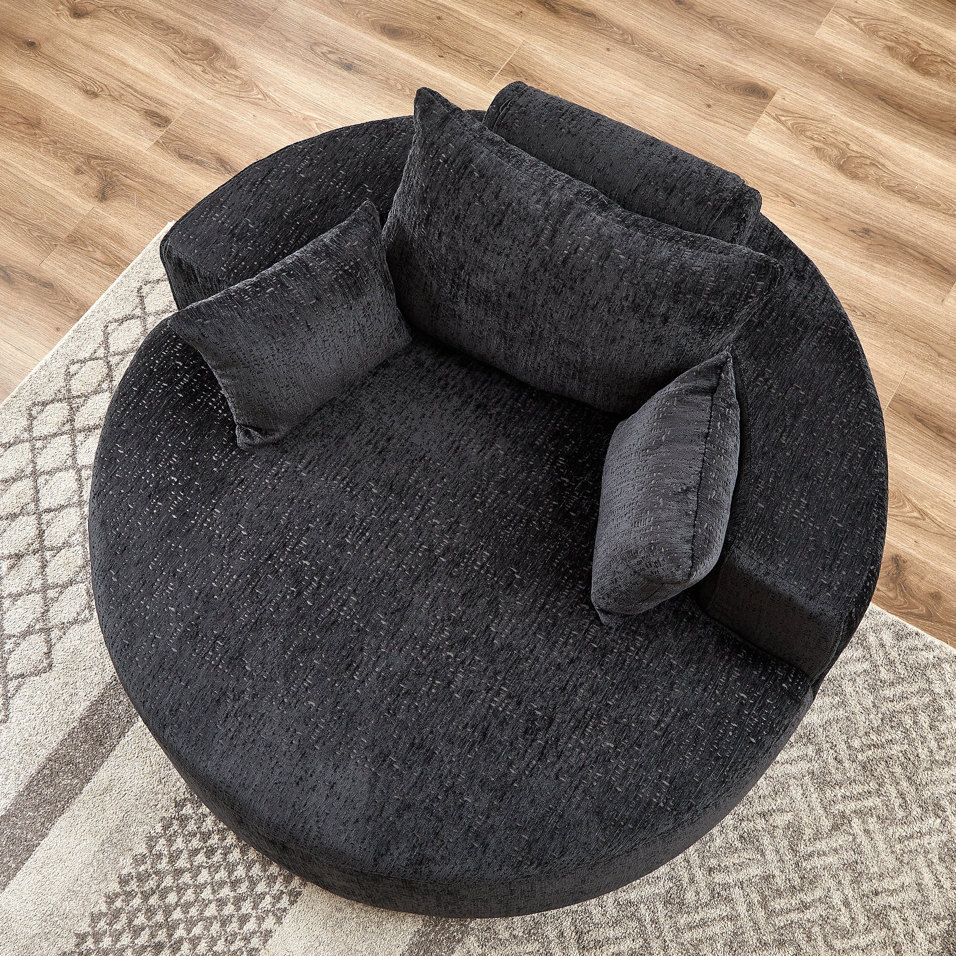Plush charcoal round sofa with textured fabric and four accent pillows perfect for cozy living rooms