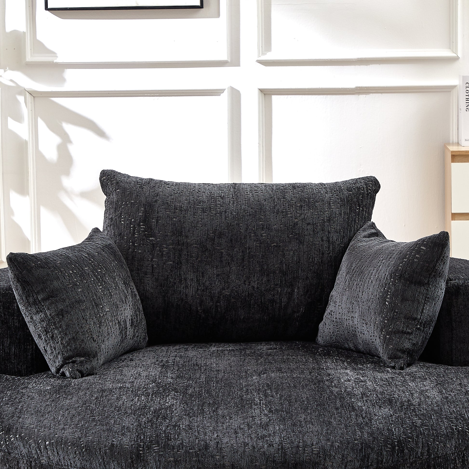 Closeup of a dark grey textured sofa cushion with a woven pattern