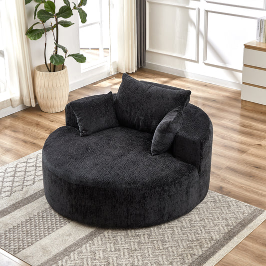 Plush black swivel chair with textured fabric and multiple accent pillows for a cozy living room