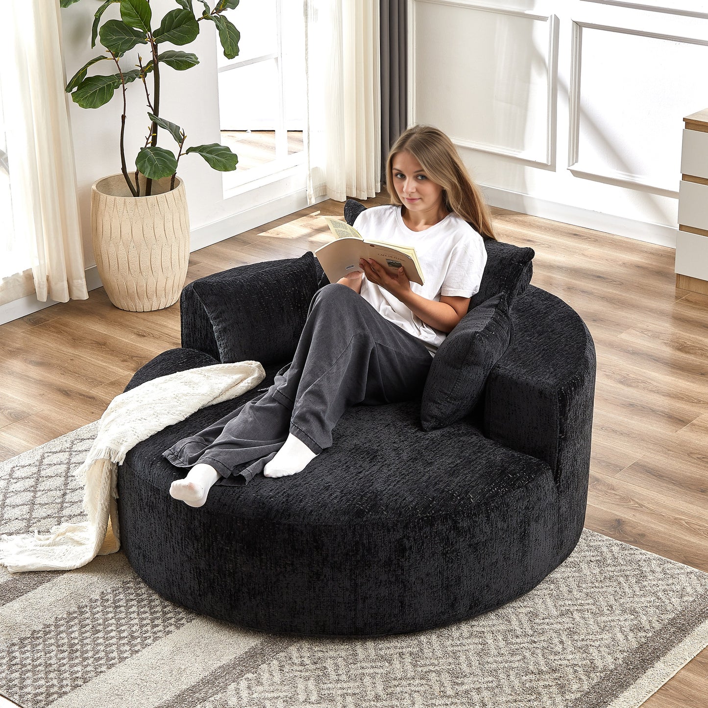 Plush black round accent chair with textured upholstery perfect for a cozy reading nook