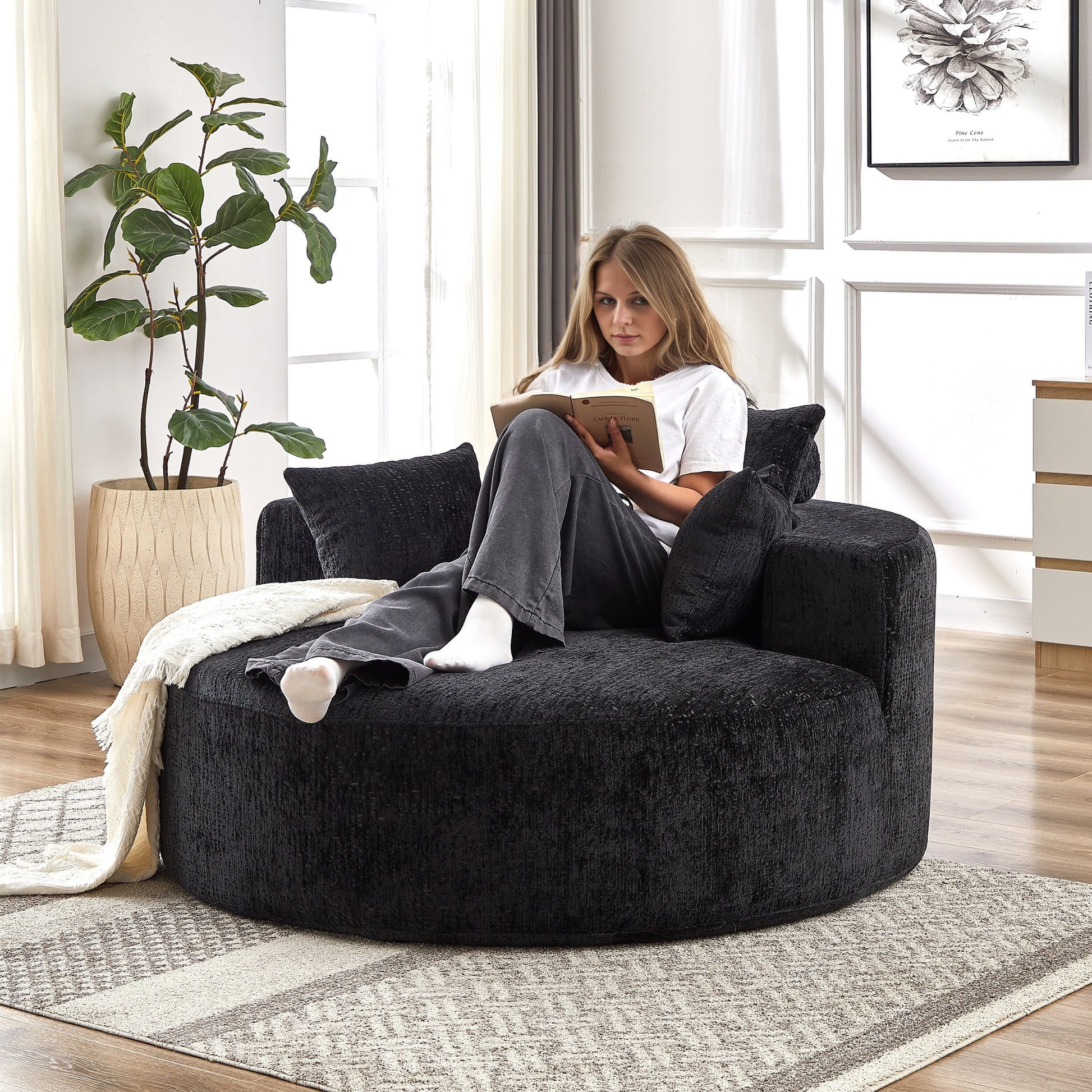 Large black boucle fabric accent chair with plush pillows perfect for cozy reading nooks