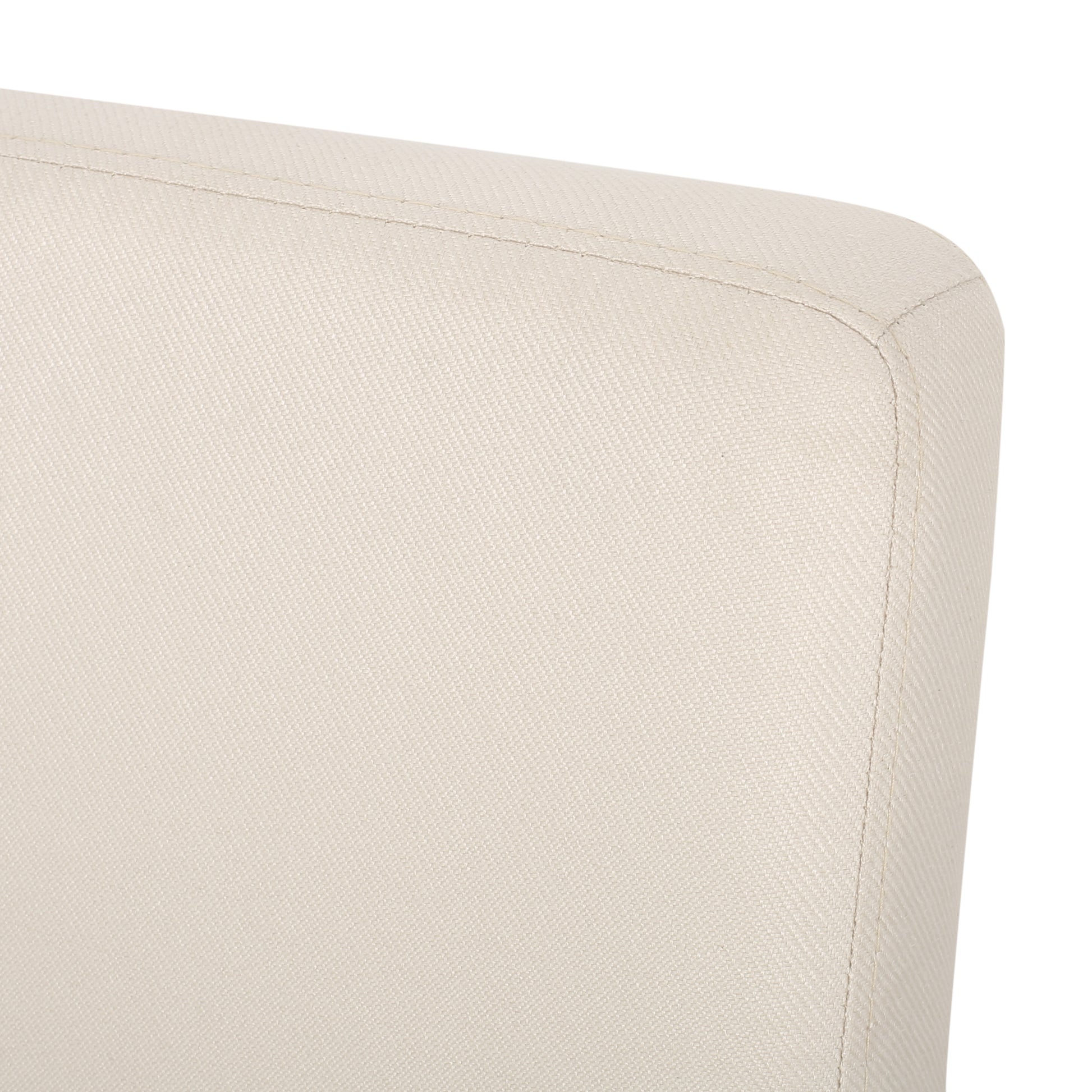 Closeup of textured offwhite fabric on a chairs curved backrest showing stitching detail