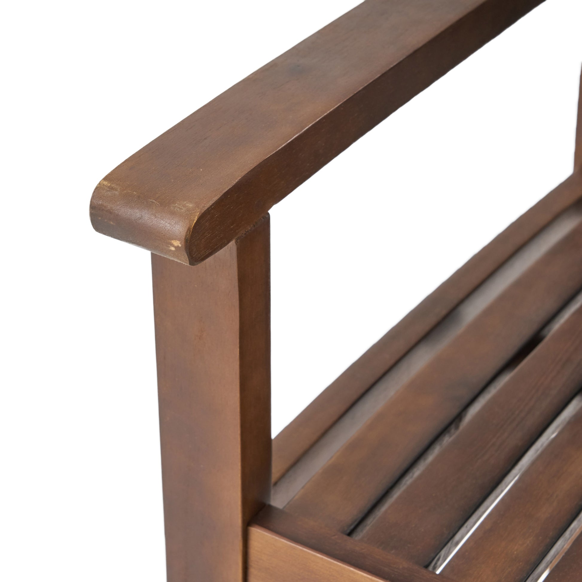 Closeup of a brown wooden slatted bench armrest and seat showcasing durable outdoor furniture design
