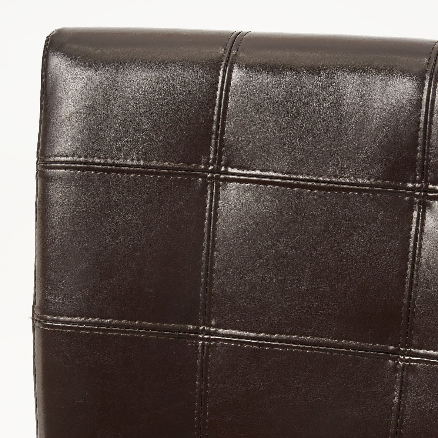 Closeup of dark brown faux leather upholstery with diamond stitching detail
