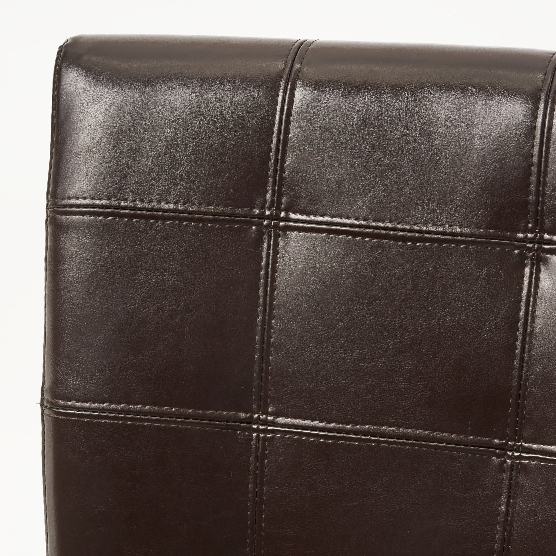 Closeup of dark brown faux leather upholstery with diamond stitching detail