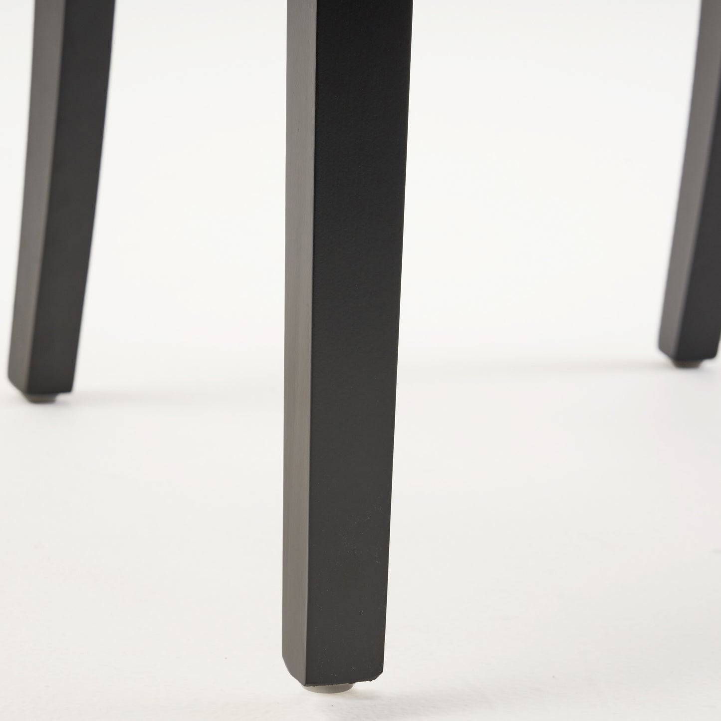 Black metal table leg with a protective floor cap