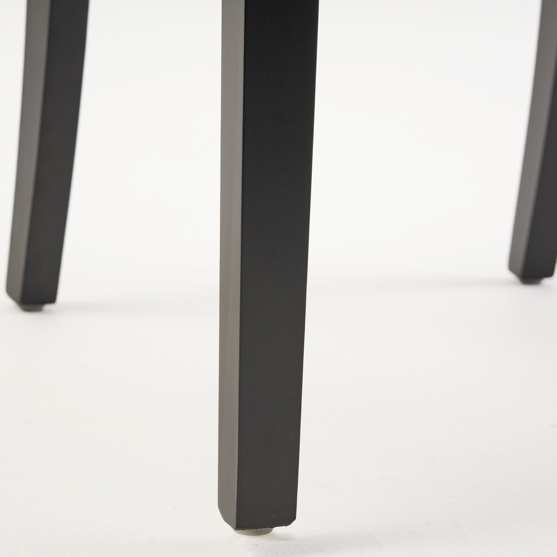 Black metal table leg with a protective floor cap