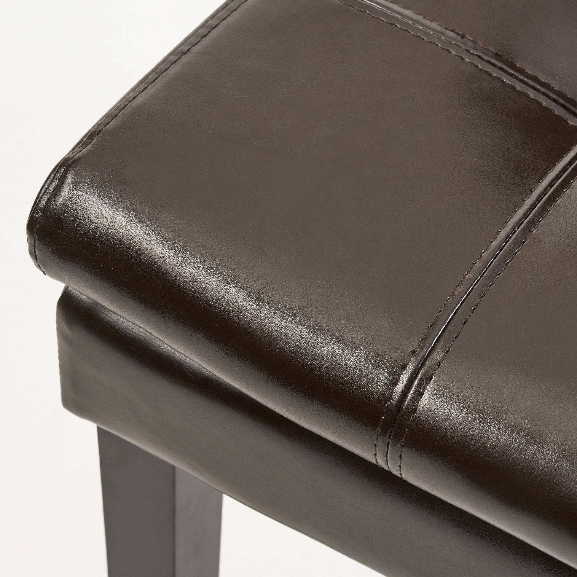 Dark brown faux leather ottoman with stitched panel detail and sturdy dark legs
