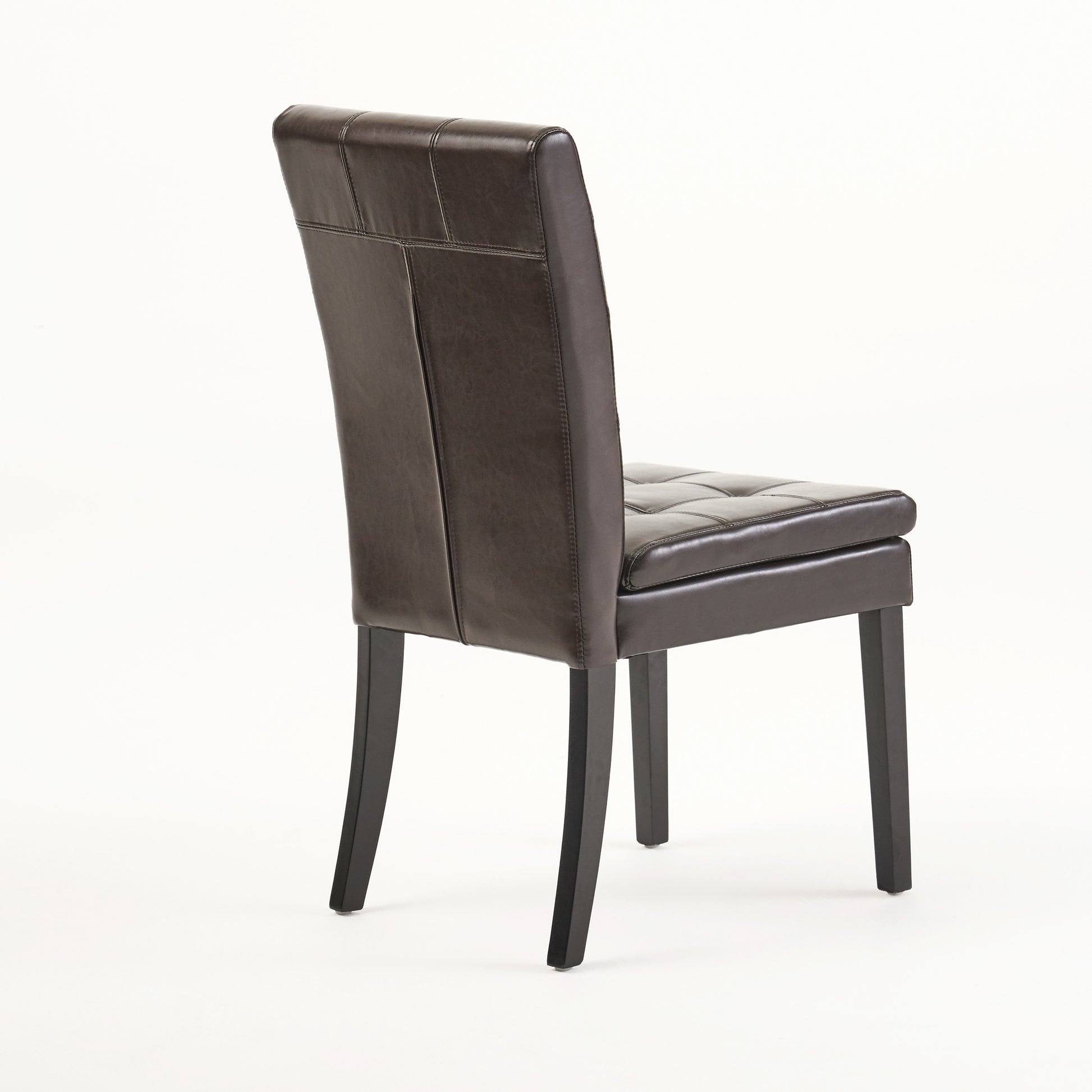 Dark brown faux leather dining chair with tufted seat and stitched backrest on wooden legs