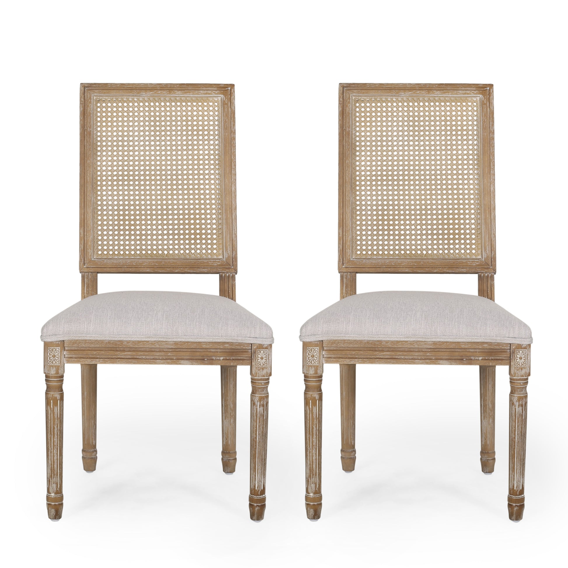 Two distressed wood dining chairs with cane backs and neutral linen seats perfect for farmhouse style