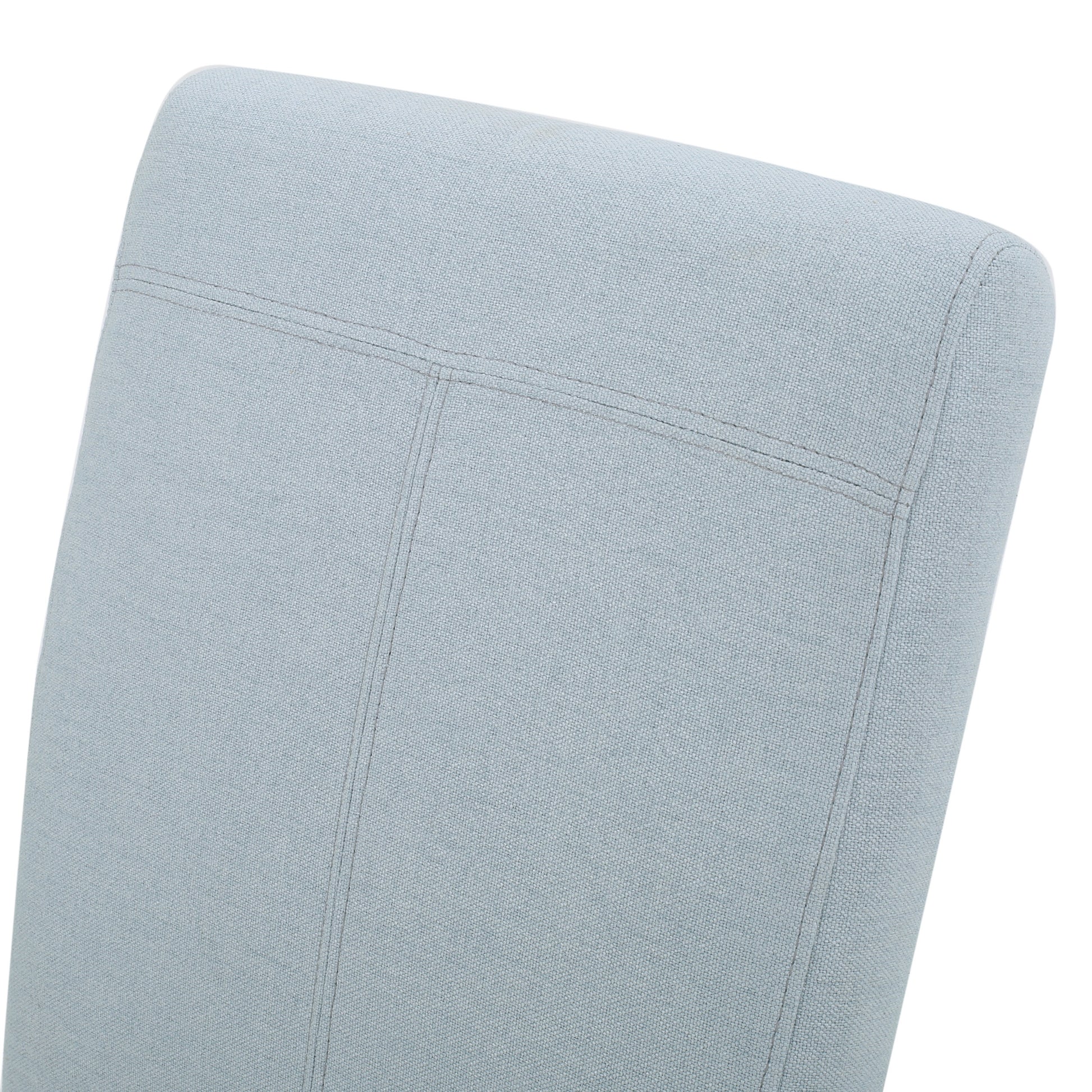 Closeup of a light blue fabric chair back with detailed stitching for modern elegance