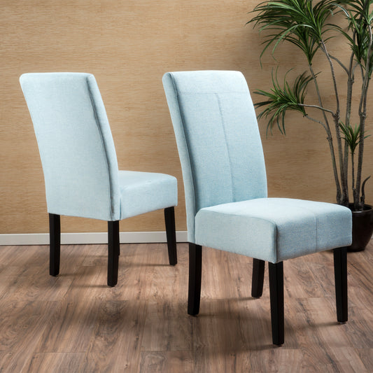 Two light blue upholstered dining chairs with black legs on a wood floor