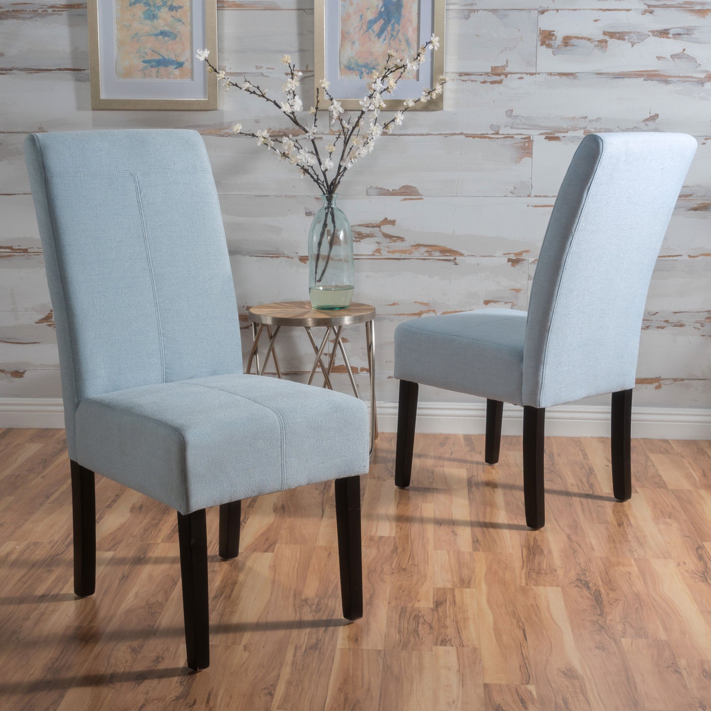 Light blue fabric dining chair with high back and dark wooden legs