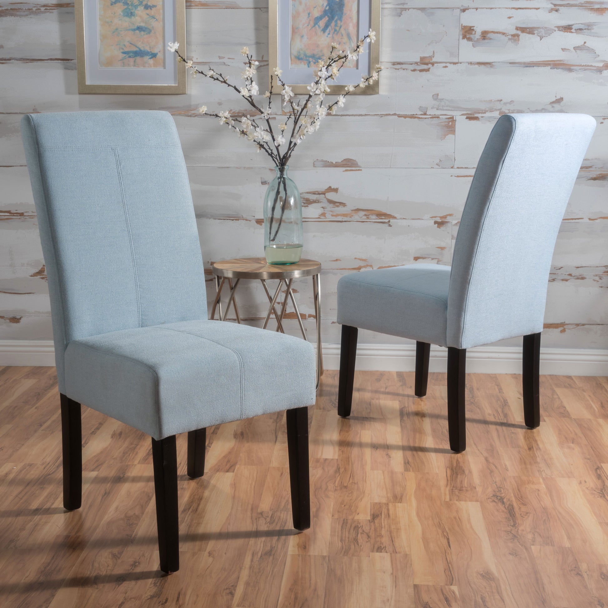 Light blue fabric dining chair with high back and dark wooden legs