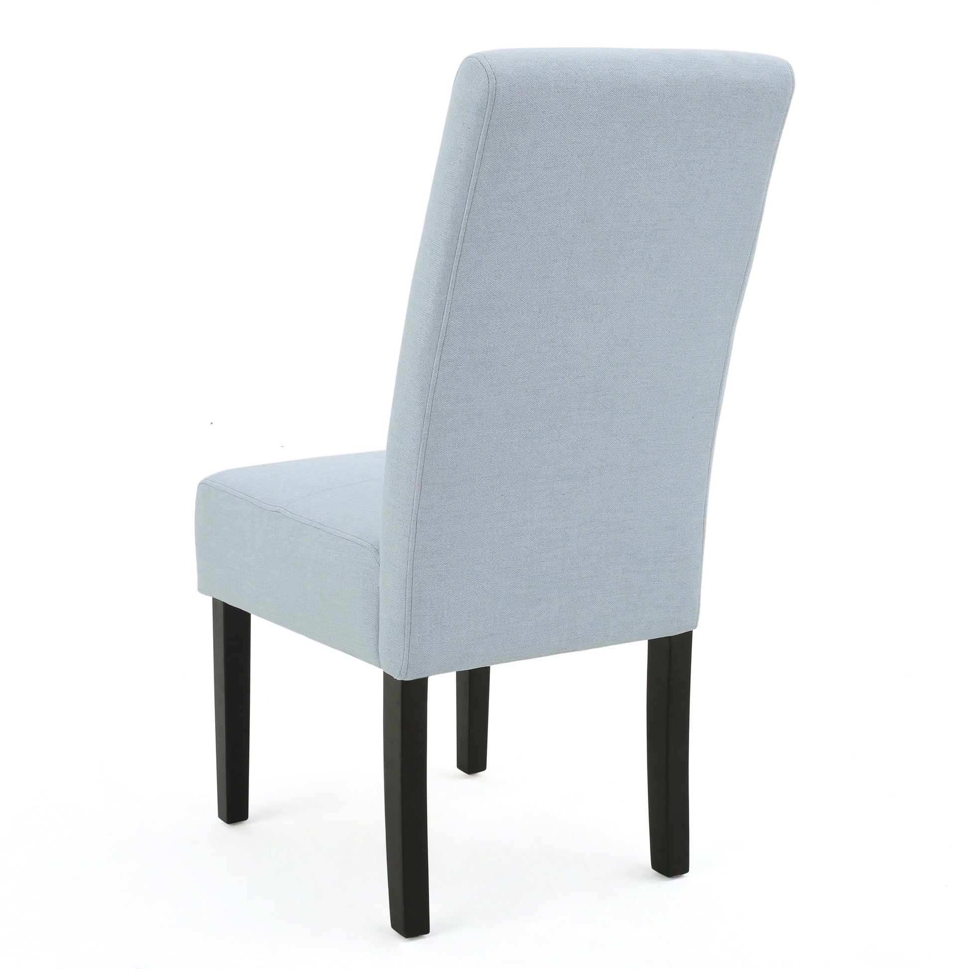 Light blue upholstered dining chair with dark wood legs from the back