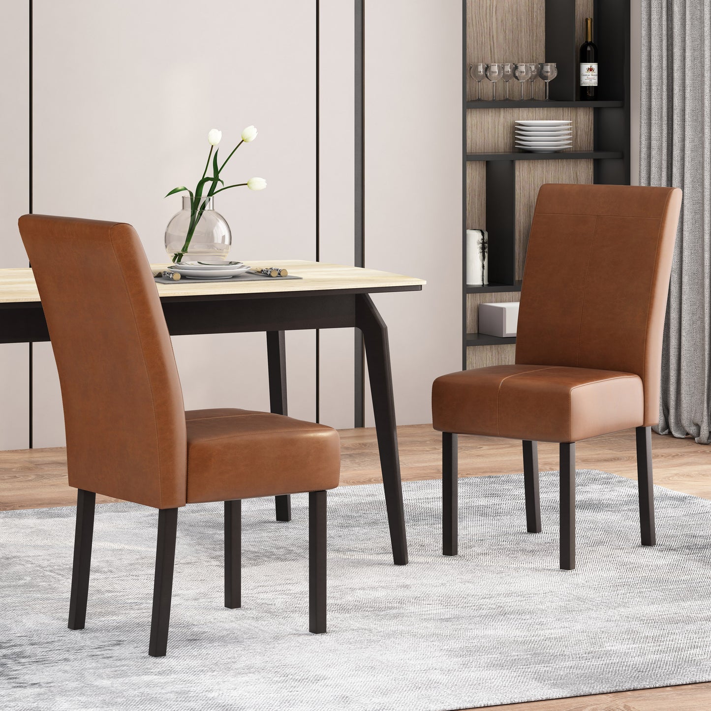 Two tan faux leather dining chairs with dark metal legs set at a modern dining table