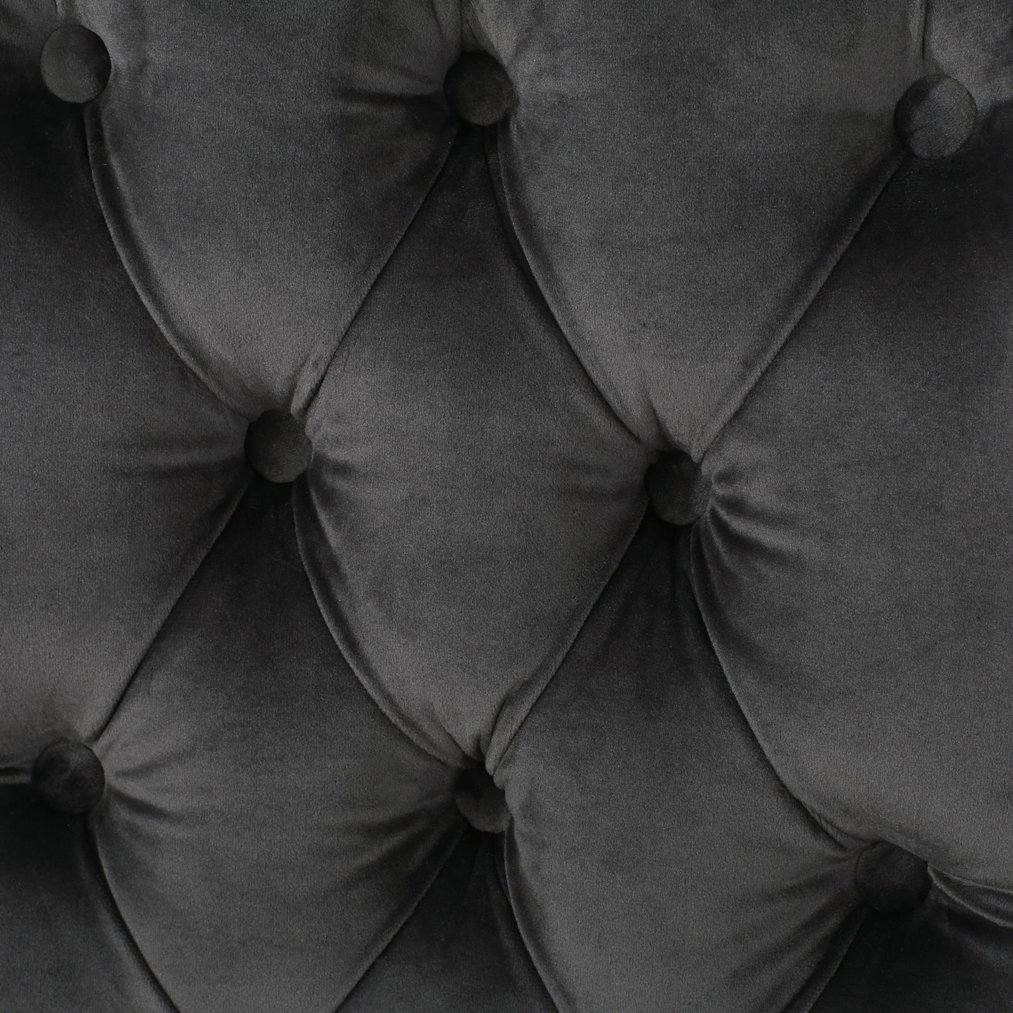 Closeup of dark gray velvet tufted upholstery fabric ideal for furniture
