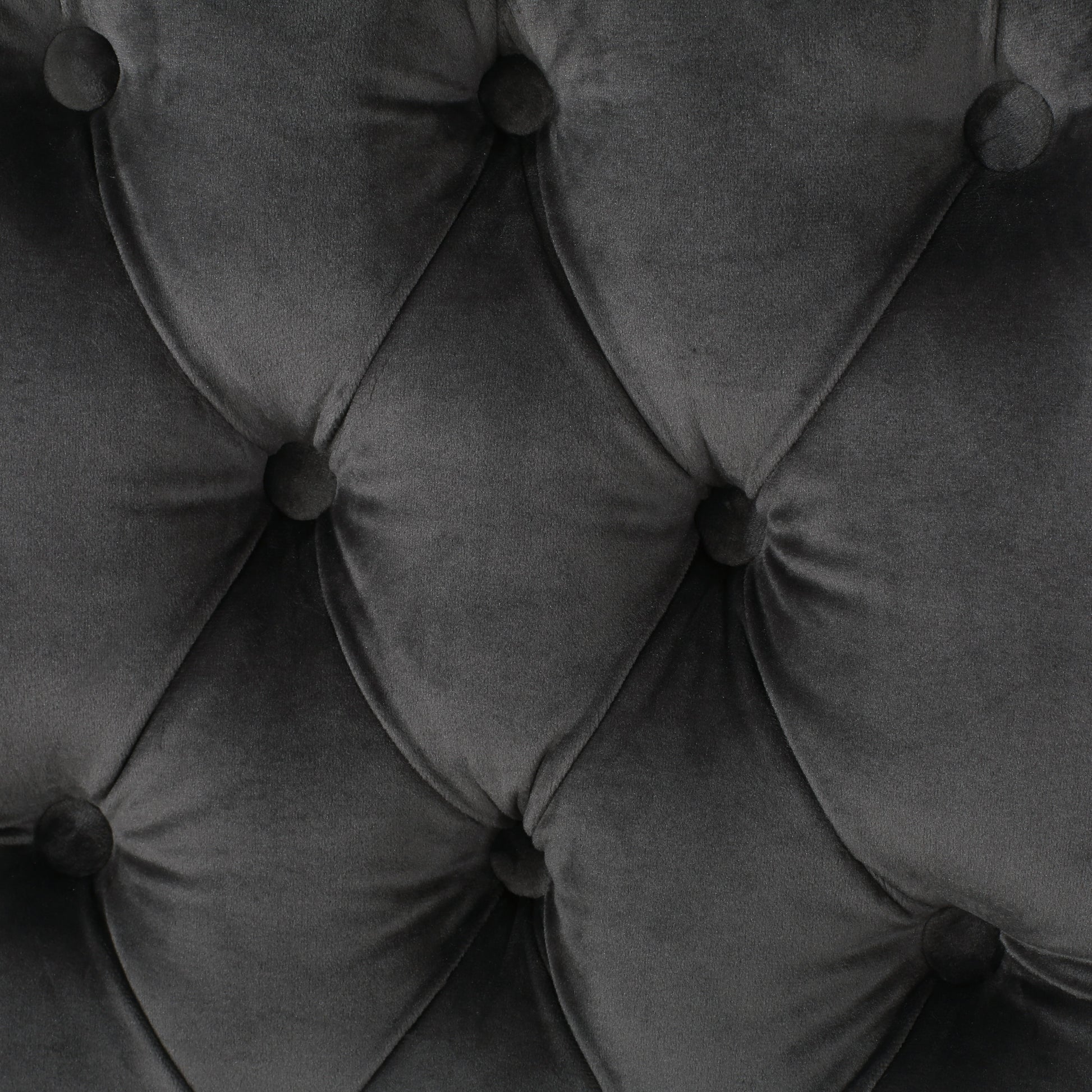 Closeup of dark gray velvet tufted upholstery fabric ideal for furniture